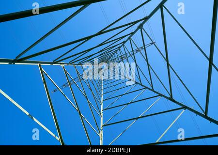 Steel construction of a power pole and blue cloudless sky Stock Photo