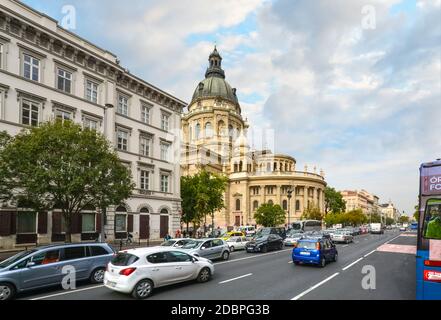 Tourists and local Hungarians drive by St. Stephen's Basilica, a Roman Catholic basilica in Budapest, Hungary Stock Photo