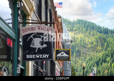 A sign hangs outside a business in the historic district of the mining town of Wallace, Idaho, in the Silver Valley. Stock Photo