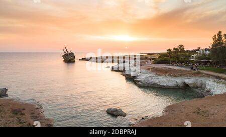 Aerial bird’s eye view of the abandoned ship wreck EDRO III in Pegeia, Paphos, Cyprus from above at sunset. The rusty shipwreck stranded on Peyia rock Stock Photo