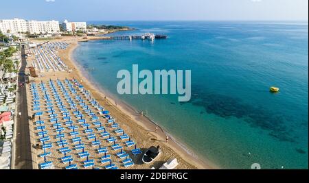 Aerial bird's eye view of Sunrise beach at Fig tree in Protaras, Paralimni, Famagusta, Cyprus. The famous tourist attraction family bay with golden sa Stock Photo