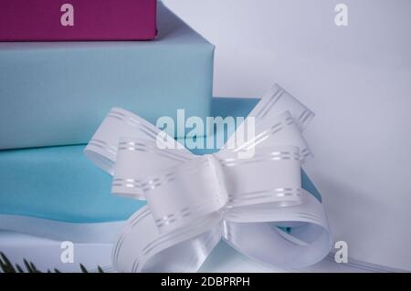 three cardboard gift boxes with a bow on a light background Stock Photo