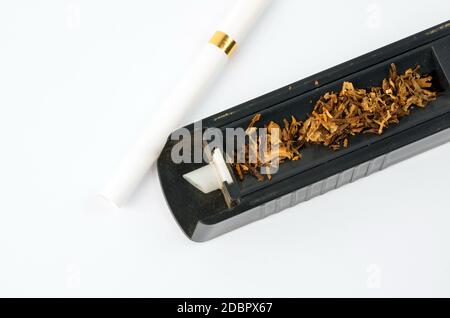 Tobbaco cigarette making machine on the white Stock Photo