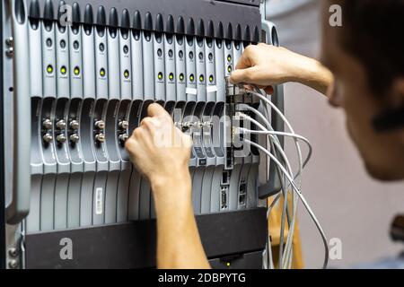 Technician engineer fixing problem with servers and data in cables room Stock Photo
