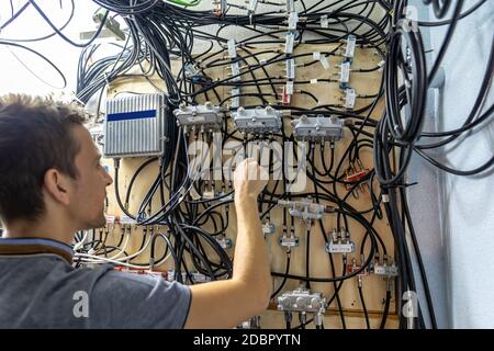 Technician engineer fixing problem with servers and data in cables room Stock Photo