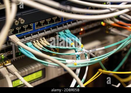Cables connected to servers in a cables room Stock Photo