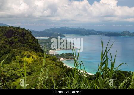 Panoramic view at the landscape on Seychelles island Mahé with clear blue water and green mountains Stock Photo