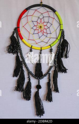 Beautiful multicolored handmade dreamcatcher with sea shells on white background. Stock Photo