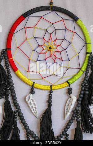 Beautiful multicolored handmade dreamcatcher with sea shells on white background. Stock Photo