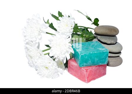 soaps off various shades with grey sone pebbles and flowers Stock Photo