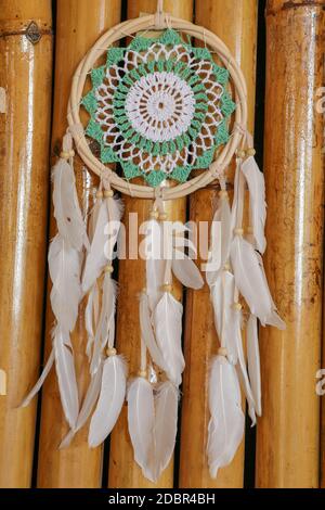 Beautiful green dream catcher on wodden background. Stock Photo