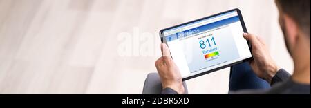 Online Credit Score Check Using Tablet Computer Stock Photo