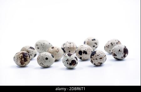 Quail eggs isolated on white background. Group of quail eggs close-up isolated on a white background. Top view. Detailed closeup of spotted quail eggs Stock Photo