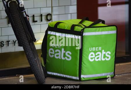 Bucharest, Romania - November 12, 2020: An Uber Eats food delivery courier delivers food in Bucharest, Romania. Stock Photo