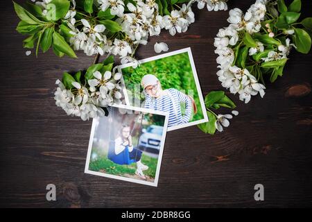 Two square photos with spring flowers on wood table background. Flat lay. Stock Photo