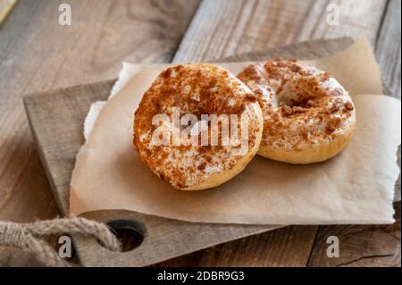 Two donuts on the wooden board Stock Photo