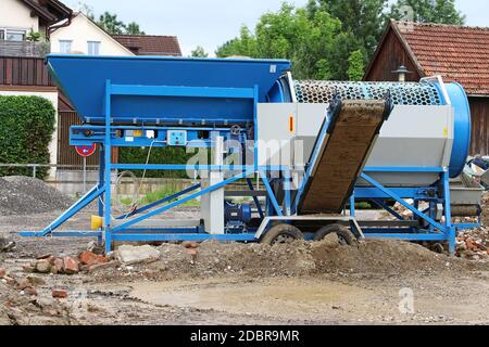 https://l450v.alamy.com/450v/2dbr9mr/a-mobile-stone-crusher-or-building-rubble-shredder-for-crushing-construction-material-stones-and-bricks-2dbr9mr.jpg