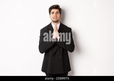 Image of hopeful man praying, begging please, standing over white ...