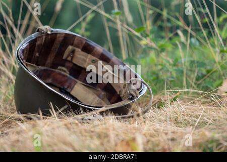 a US M1 helmet on the ground Stock Photo