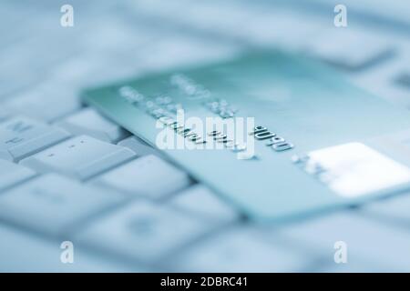 Bank creadit card on keyboard. Concept of online banking and internet purchase. Soft focus. Stock Photo