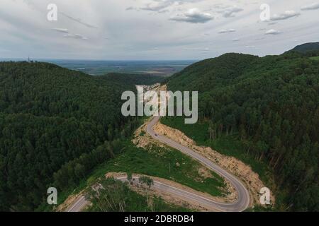 Aerial top vew of winding road in the mountains, drone shot. Altai Krai, Western Siberia, Russia. Road to Resort town Belokurikha 2 Stock Photo