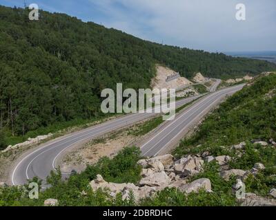 Aerial top vew of winding road in the mountains, drone shot. Altai Krai, Western Siberia, Russia. Road to Resort town Belokurikha 2 Stock Photo