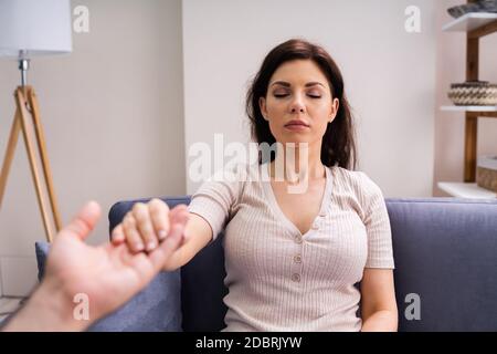 Hypnotherapy Psychotherapy Treatment. Woman Hypnotized By Hypnotist Stock Photo