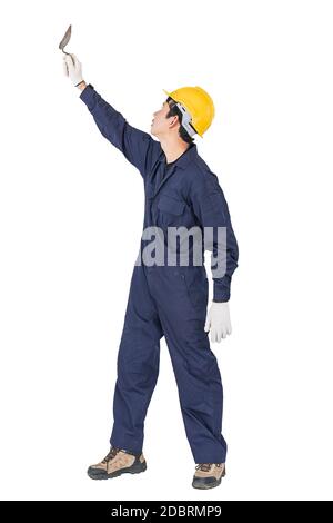 Portrait of a workman with blue coveralls and hardhat in a uniform holding steel trowel on white background with clipping path Stock Photo