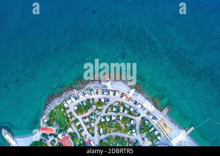 Camping by the sea and crystal clear stone beach aerial view in Krk, island in Kvarner bay of Croatia Stock Photo