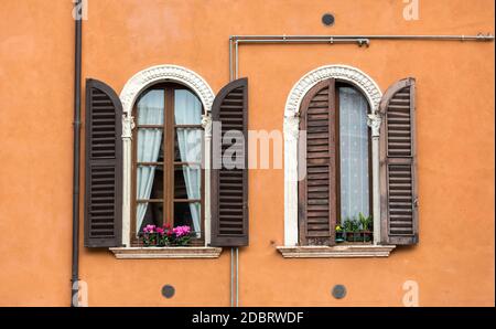 Old  windows with  wooden shutters and curtain in Italy Stock Photo