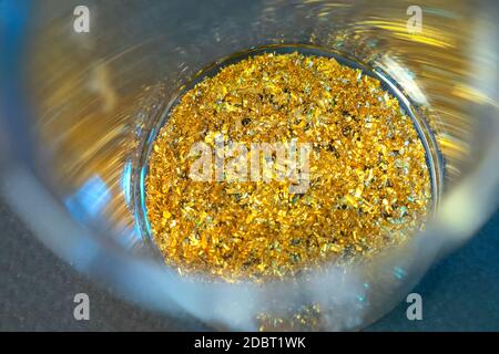 Pieces of gold in a cup. Encouraged RAM contacts. Stock Photo