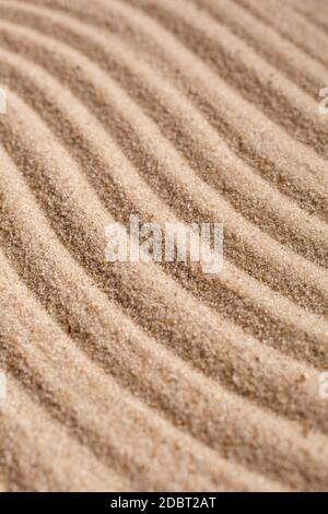 Sand Texture. Brown sand. Background from fine sand. Sand background. Waves texture. Stock Photo