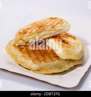 Fried potato pies. Patties with dill. Cheap recipe for homemade fried pies on a white background. Easy meal idea. Side view. Stock Photo