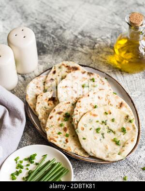 Onion naan - traditional indian bread. pita bread or scones with green onions Stock Photo