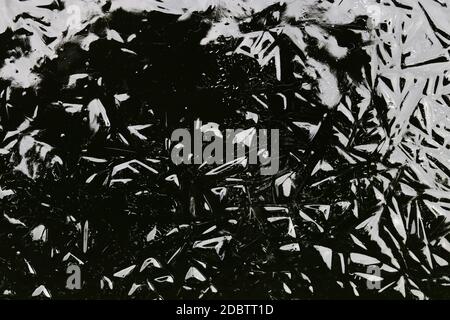 An abstract pattern in black and grey has been created on frozen water Stock Photo
