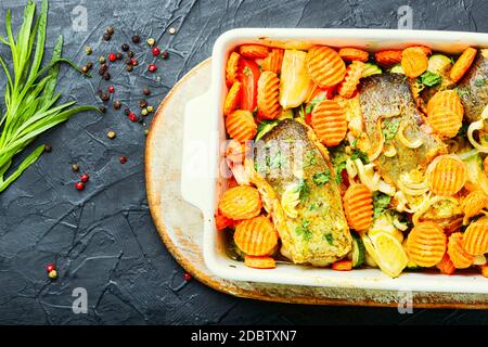 Baked fish steaks with grilled vegetables in baking dish.Delicious healthy grilled fish Stock Photo