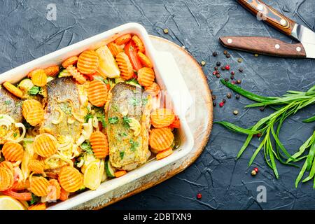 Baked fish steaks with grilled vegetables in baking dish.Delicious healthy grilled fish Stock Photo