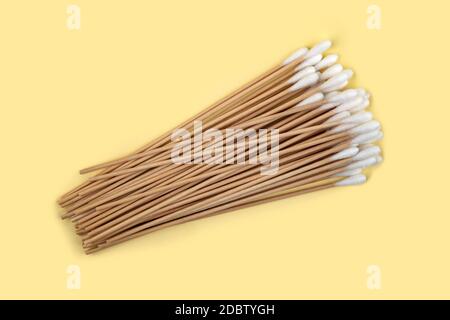 Medical cotton swabs on yellow background Stock Photo