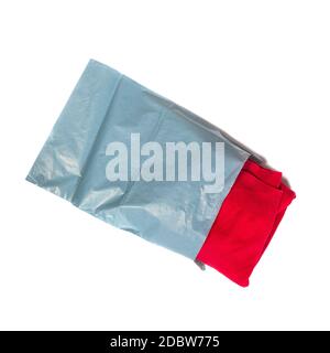 red jumper packed in gray mailing bag on white background Stock Photo