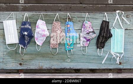 Various purchased and self-sewn protective masks, or makeshift masks against the corona virus Stock Photo