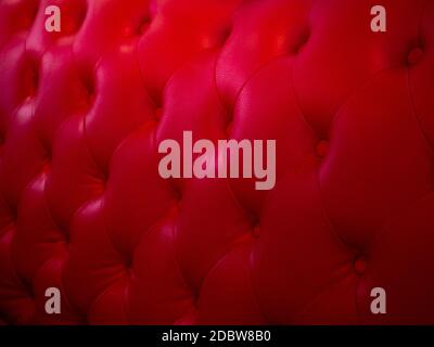 Background from leather of cushion. Red leather from retro chairs. The seat has a vintage style texture Stock Photo