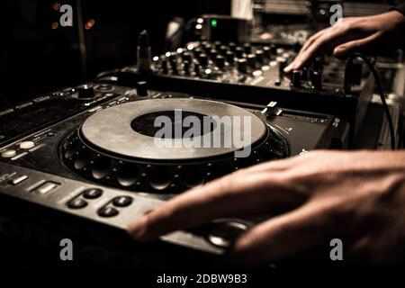 Dj turntables mixing house techno music in club. Beach party disco vibes. Sounds like tomorrowland and burning man. Wedding dj for wedding party. Stock Photo
