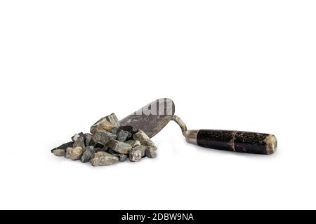 Stones used in conjunction with cement, including trowel, are used for separate construction on a white background. Stock Photo