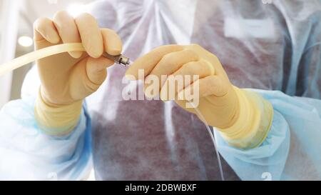 The doctor prepares a dropper to inject drugs into the body. Diffusion system. Medical dropper. Macro photo. Copy space Stock Photo