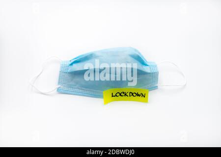 Single use medical face mask with handwritten message on post-it note Lockdown isolated over white background, coronavirus protection concept Stock Photo