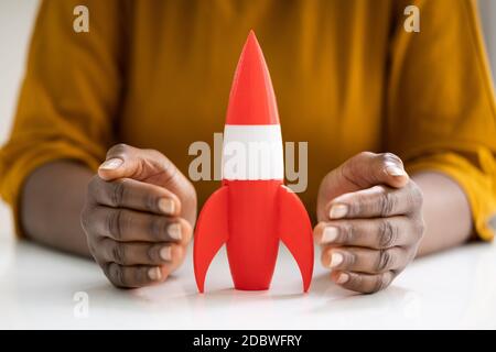Woman Hands Protecting Red Rocket Launch. Speed Start