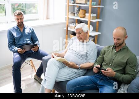Three Generation Men Spending Time Together At Home Stock Photo