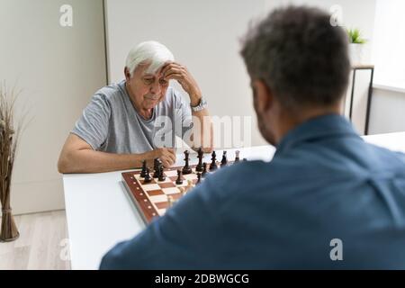 Elderly Senior Playing Chess Table Board Game Stock Photo