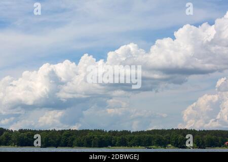 Lake in Polish Masuria on a sunny day. Picturesque cloudy sky, Masurian Lakeland, Poland Stock Photo