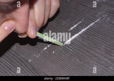 Substance abuse and drug use and sniffing cocaine powder, close-up Stock Photo